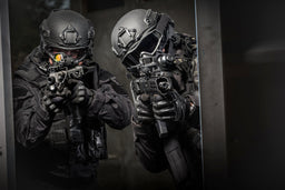 Two SWAT members breaching a door while wearing the Tactical Air-Purifying Respirator mask (TAPR)